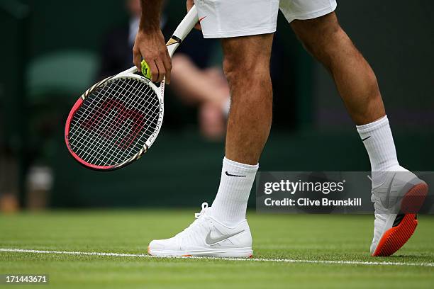 Roger Federer of Switzerland' trainers during his gentlemen's singles first round match against Victor Hanescu of Romania on day one of the Wimbledon...
