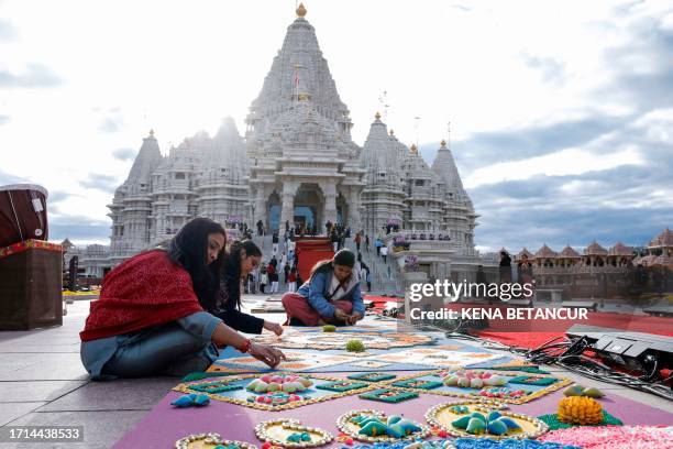 Volunteers make preparations before the opening ceremony of the BAPS Swaminarayan Akshardham temple in Robbinsville, New Jersey on October 8, 2023....