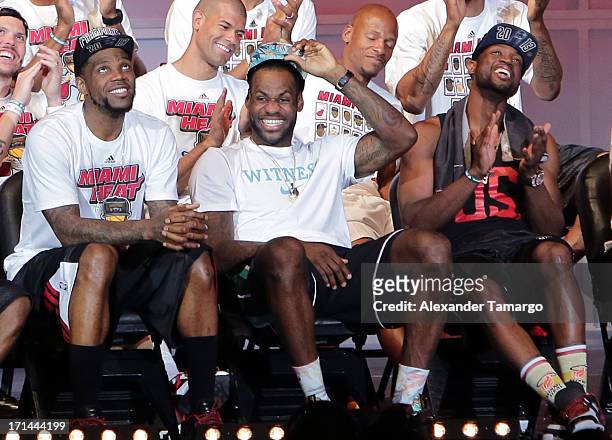 Udonis Haslem, LeBron James and Dwyane Wade of the Miami Heat attend their NBA Championship victory rally at the AmericanAirlines Arena on June 24,...