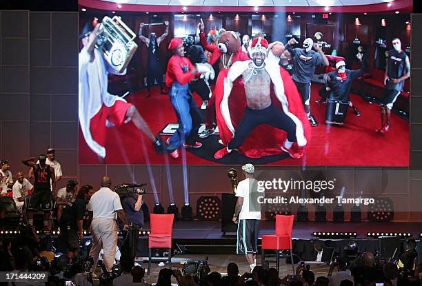 LeBron James of the Miami Heat watches a video during the NBA Championship victory rally at the AmericanAirlines Arena on June 24, 2013 in Miami,...