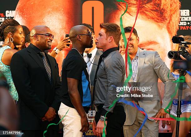 Floyd Mayweather and Canelo Alvarez face-off during a news conference at the Pedestrian Walk in Times Square on June 24, 2013 in New York City. Floyd...