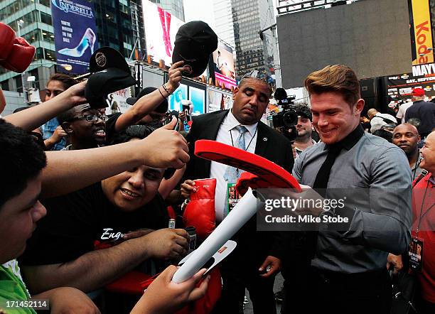 Canelo Alvarez signs autographs following a news conference at the Pedestrian Walk in Times Square on June 24, 2013 in New York City. Floyd...