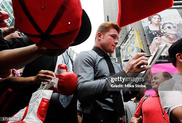 Canelo Alvarez signs autographs following a news conference at the Pedestrian Walk in Times Square on June 24, 2013 in New York City. Floyd...