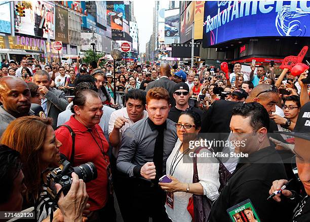 Canelo Alvarez poses for a photo with a fan following a news conference at the Pedestrian Walk in Times Square on June 24, 2013 in New York City....