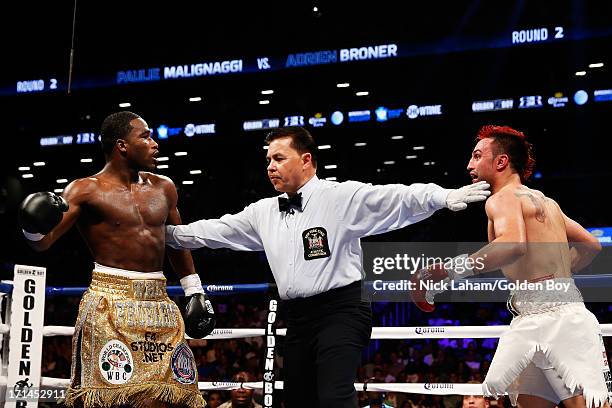 Paulie Malignaggi and Adrien Broner are separated during their WBA Welterweight Title bout at Barclays Center on June 22, 2013 in the Brooklyn...