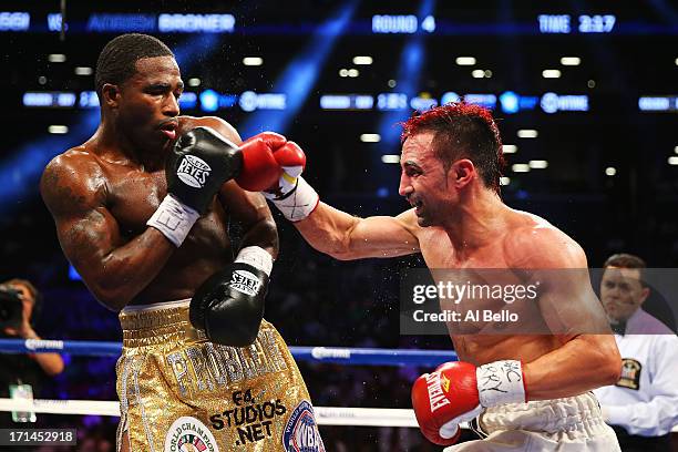 Paulie Malignaggi punches Adrien Broner during their WBA Welterweight Title bout at Barclays Center on June 22, 2013 in the Brooklyn borough of New...