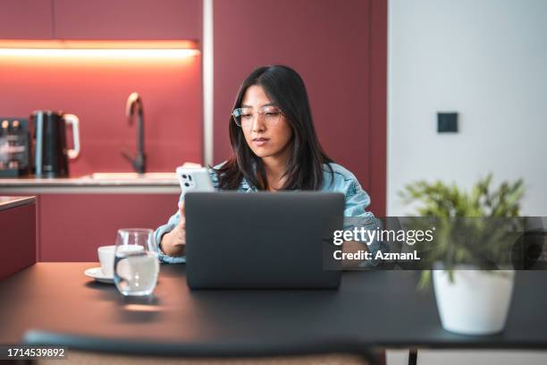 focused asian female social media manager working at home - secretary stock pictures, royalty-free photos & images