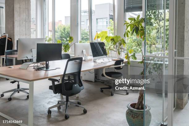 empty office with desks and computers ready - office chair stock pictures, royalty-free photos & images