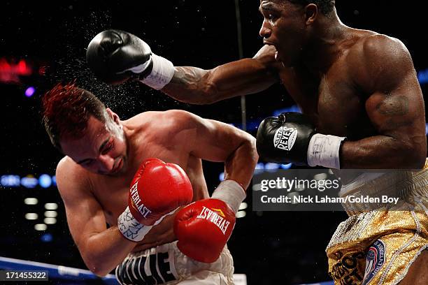 Adrien Broner punches Paulie Malignaggi during their WBA Welterweight Title bout at Barclays Center on June 22, 2013 in the Brooklyn borough of New...