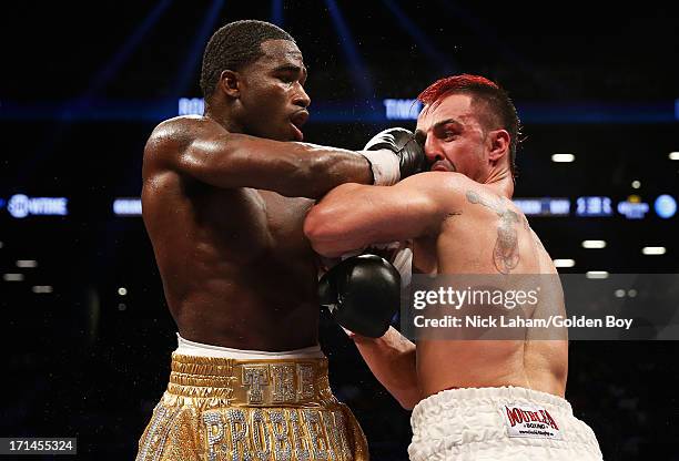 Adrien Broner punches Paulie Malignaggi during their WBA Welterweight Title bout at Barclays Center on June 22, 2013 in the Brooklyn borough of New...