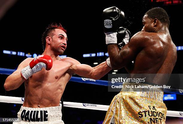 Paulie Malignaggi punches Adrien Broner during their WBA Welterweight Title bout at Barclays Center on June 22, 2013 in the Brooklyn borough of New...