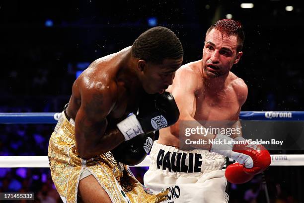 Paulie Malignaggi punches Adrien Broner during their WBA Welterweight Title bout at Barclays Center on June 22, 2013 in the Brooklyn borough of New...