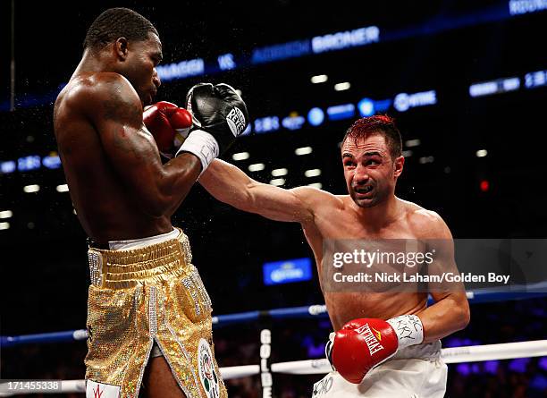 Paulie Malignaggi punches Adrien Broner during their WBA Welterweight Title bout at Barclays Center on June 22, 2013 in the Brooklyn borough of New...