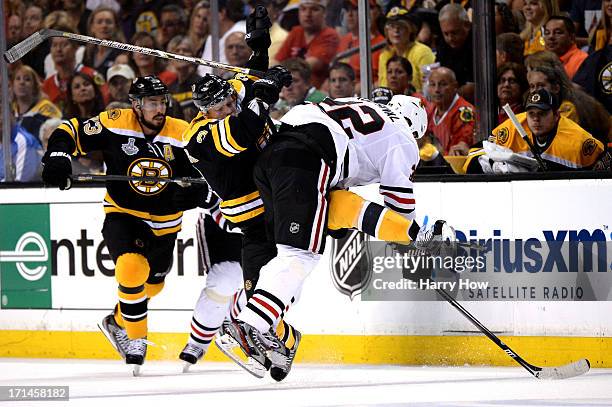 Carl Soderberg of the Boston Bruins checks Michal Rozsival of the Chicago Blackhawks in Game Six of the 2013 NHL Stanley Cup Final at TD Garden on...