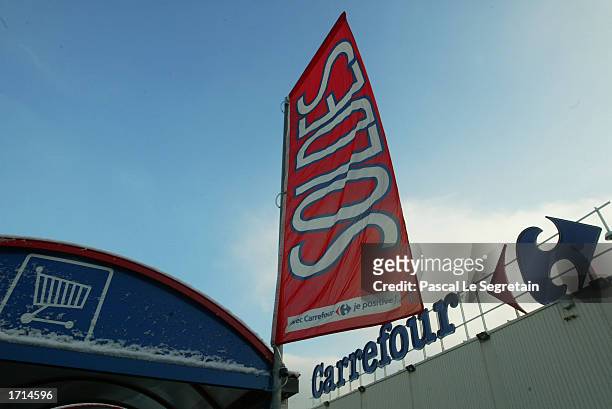 Large sale banner hangs outside the Carrefour supermarket January 8, 2003 in Chambourcy, France. The market begins the first day of a four-week long...