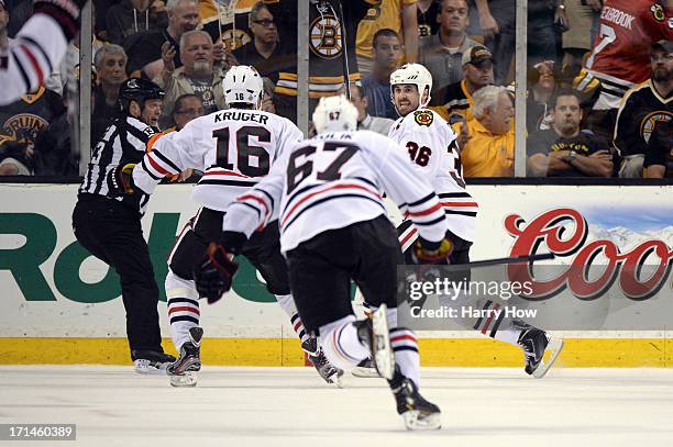 Dave Bolland of the Chicago Blackhawks celebrates with Marcus Kruger after scoring the game winning goal late in the third period against Tuukka Rask...