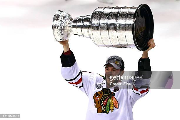 Jonathan Toews of the Chicago Blackhawks hoist the Stanley Cup Trophy after defeating the Boston Bruins in Game Six of the 2013 NHL Stanley Cup Final...