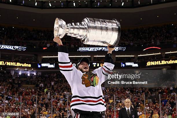 Jonathan Toews of the Chicago Blackhawks hoist the Stanley Cup Trophy after defeating the Boston Bruins in Game Six of the 2013 NHL Stanley Cup Final...