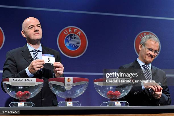 Gianni Infantino, UEFA General Secretary, shows the number 3 as Giorgio Marchetti, UEFA Competition Director, opens a ball during the UEFA Europa...