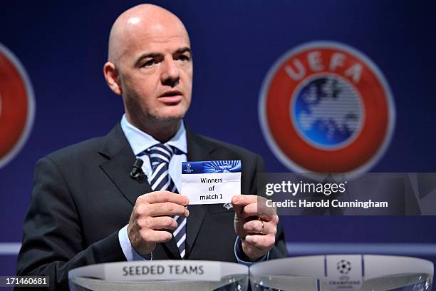 Gianni Infantino, UEFA General Secretary, shows the name Winners of match 1 during the UEFA Champions League Q2 qualifying round draw at the UEFA...