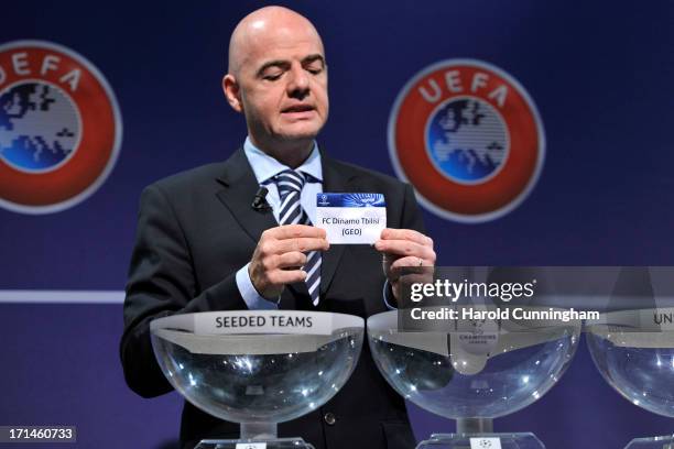 Gianni Infantino, UEFA General Secretary, shows the name Dinamo Tbilisi during the UEFA Champions League Q2 qualifying round draw at the UEFA...