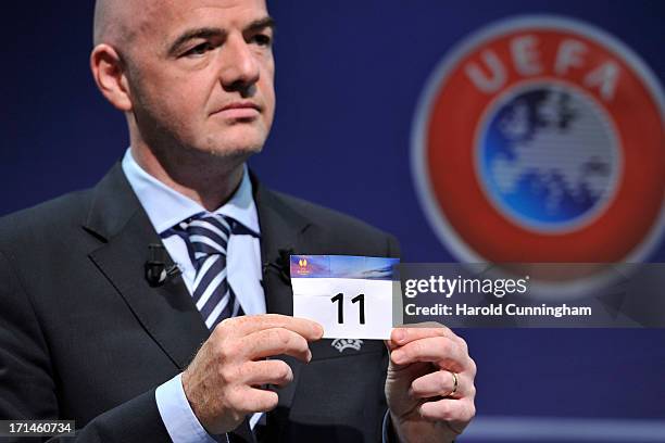 Gianni Infantino, UEFA General Secretary, shows the number 11 during the UEFA Europa League Q1 qualifying round draw at the UEFA headquarters on June...