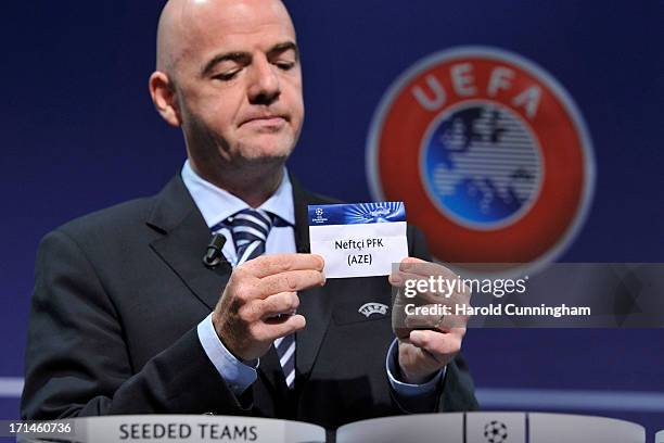 Gianni Infantino, UEFA General Secretary, shows the name Neftchi PFK during the UEFA Champions League Q2 qualifying round draw at the UEFA...