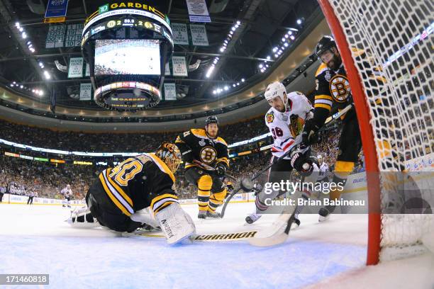 Dave Bolland of the Chicago Blackhawks scores a goal to win the game against the Boston Bruins in Game Six of the Stanley Cup Final at TD Garden on...