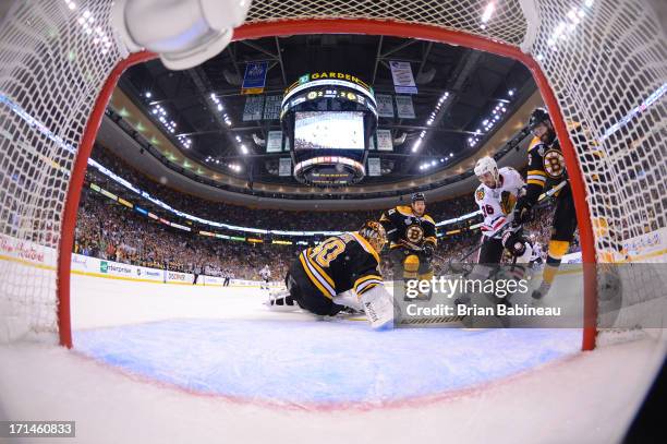 Dave Bolland of the Chicago Blackhawks scores a goal to win the game against the Boston Bruins in Game Six of the Stanley Cup Final at TD Garden on...