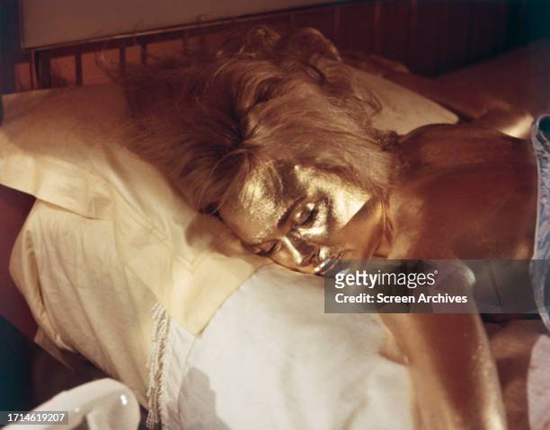 Shirley Eaton lying on bed painted gold in the classic scene from the 1964 James Bond movie 'Goldfinger'.