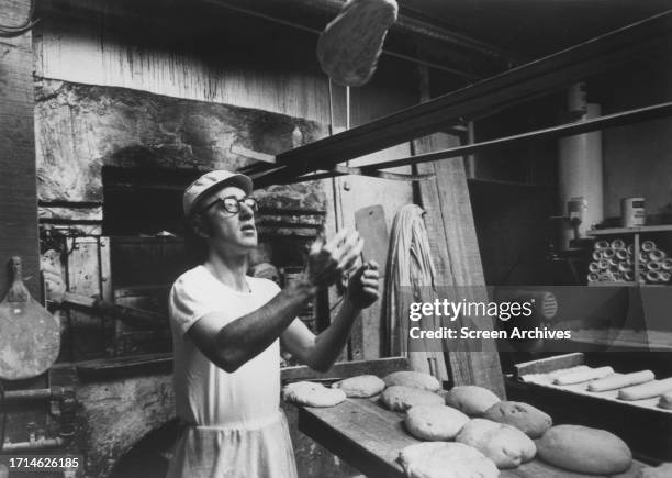 Woody Allen tossing pizza dough in a scene from the 1972 movie 'Play it Again Sam'.