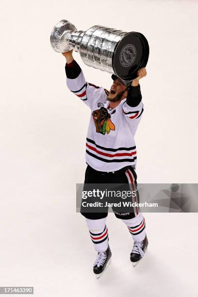 Jonathan Toews of the Chicago Blackhawks celebrates with the Stanley Cup after they won 3-2 against the Boston Bruins in Game Six of the 2013 NHL...