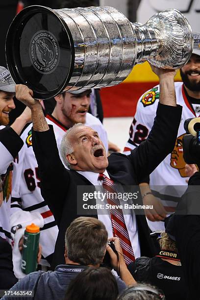 Head Coach Joel Quenneville of the Chicago Blackhawks hoists the Stanley Cup after the win against the Boston Bruins in Game Six of the Stanley Cup...