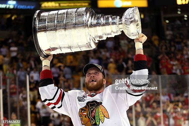 Bryan Bickell of the Chicago Blackhawks celebrates with the Stanley Cup after Game Six of the 2013 NHL Stanley Cup Final at TD Garden on June 24,...