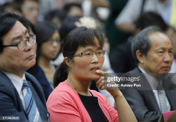 Yuan Weijing, wife of Chinese lawyer and human rights activist Chen Guangcheng listens to at Chen's speech at the Legislative Yuan on June 25, 2013...