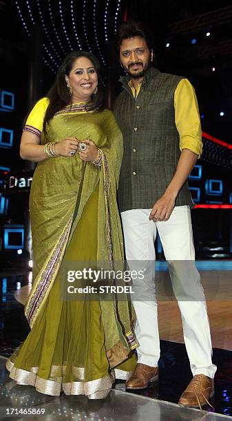 Indian Bollywood actor Riteish Deshmukh poses with choreographer judge Geeta Kapoor during the promotion of the forthcoming Hindi film Bhaag Milkha...