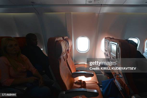 Picture taken in Moscow Sheremetyevo airport aboard a plane of Aeroflot flight from Moscow to Havana on June 24 shows the empty window seat 17A,...