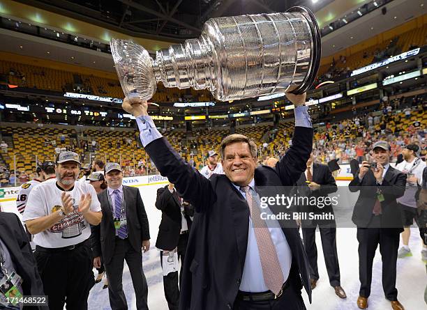 Owner and chairman Rocky Wirtz of the Chicago Blackhawks hoists the Stanley Cup after his team defeated the Boston Bruins 3-2 in Game Six of the 2013...
