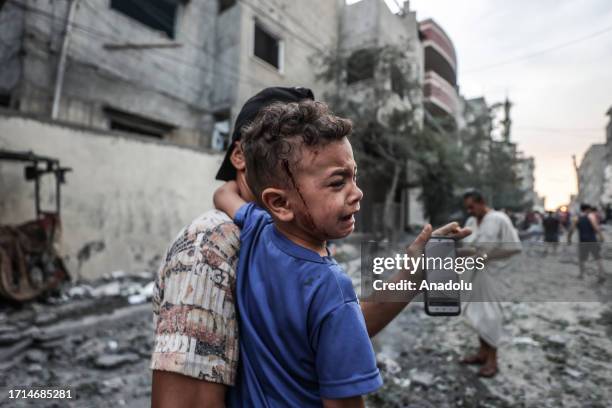 An injured Palestinian kid is seen after Israeli airstrikes at al-Shati refugee camp in Gaza Strip on October 09, 2023.