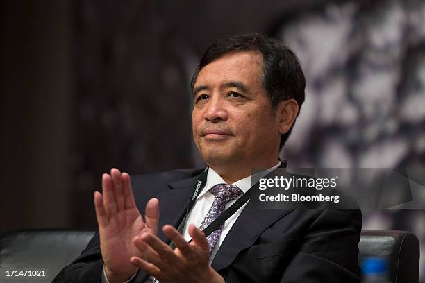 Yang Zhiqiang, chairman of Jinchuan Group Ltd., claps during the London Metal Exchange Week Asia 2013 Seminar in Hong Kong, China, on Tuesday, June...