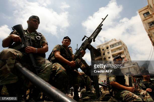 Lebanese Army soldiers patrol the area around the Bilal bin Rabah mosque in the Abra district of the southern city of Sidon on June 25 after troops...