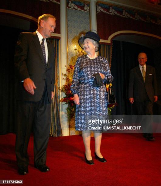 Britain's Queen Elizabeth II is greeted by Canadian Prime Minister Jean Chretien as the queen's husband Prince Philip looks on before an official...