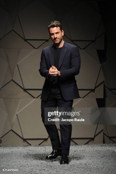 Designer Paul Surridge acknowledges the applause of the audience after the Z Zegna show during Milan Menswear Fashion Week Spring Summer 2014 on June...