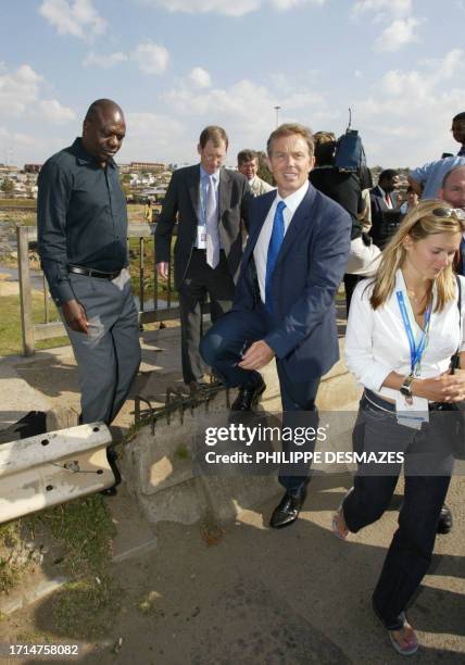 British Prime Minister Tony Blair visits 02 September 2002 the Alexandra township, one of the poorest in Johannesburg. Britain and France will each...