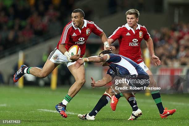 Simon Zebo of the Lions breaks a tackle during the International Tour Match between the Melbourne Rebels and the British & Irish Lions at AAMI Park...