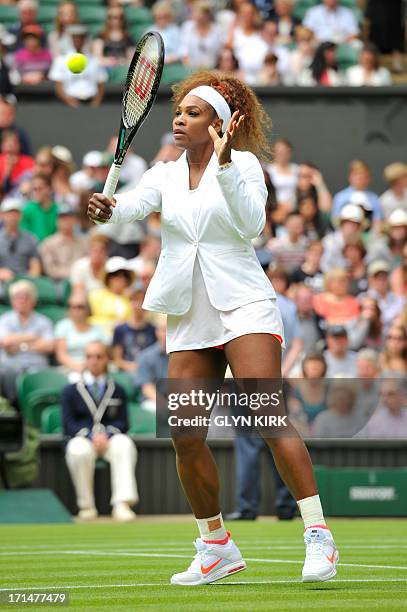 Player Serena Williams warms up ahead of the start of her women's first round match against Luxembourg's Mandy Minella on day two of the 2013...