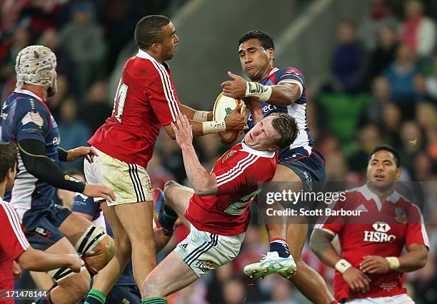 Stuart Hogg and Simon Zebo of the Lions contest a high ball with Cooper Vuna of the Rebels during the International Tour Match between the Melbourne...