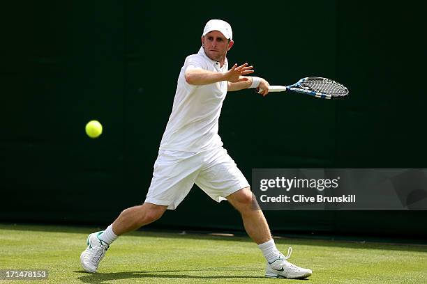 Jesse Levine of Canada plays a forehand during his Gentlemen's Singles first round match against Guido Pella of Argentina on day two of the Wimbledon...