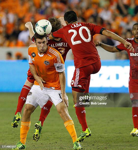 Will Bruin of Houston Dynamo and Matias Laba of Toronto FC during the game action at BBVA Compass Stadium on June 22, 2013 in Houston, Texas.