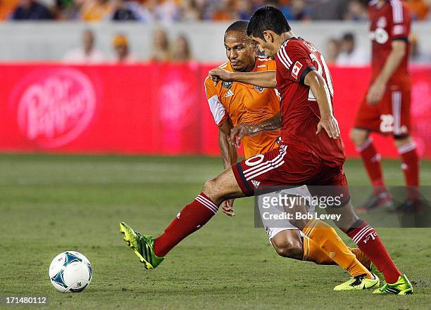 Ricardo Clark of Houston Dynamo and Matias Laba of Toronto FC during the game action at BBVA Compass Stadium on June 22, 2013 in Houston, Texas.